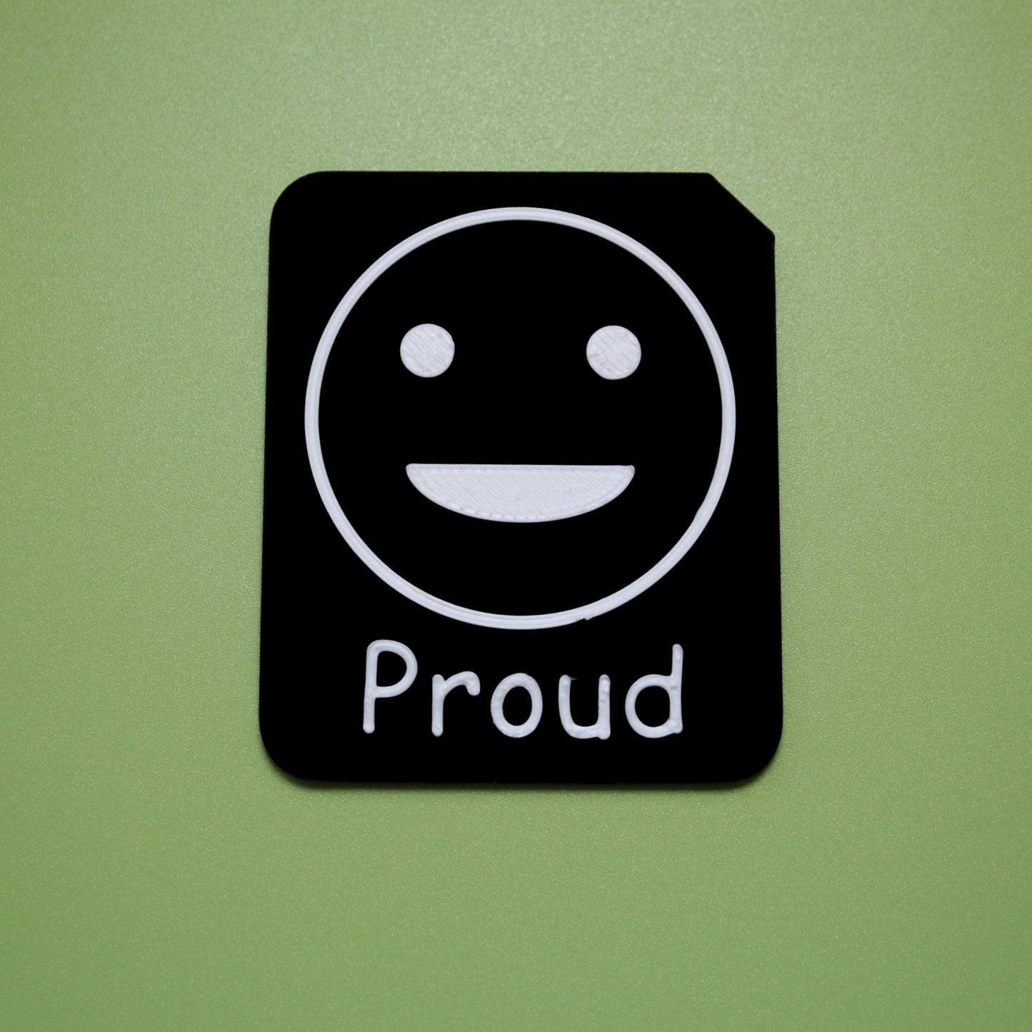 Proud tactile tile - 3D printed raised symbol showing bored face for AAC and SEND communication with vocabulary