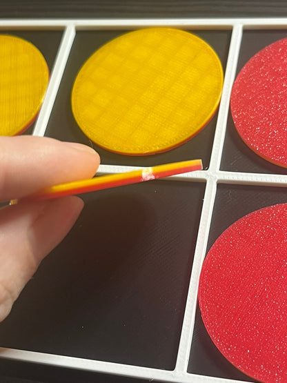 Tactile ten frame resource from above showing raised slots for counters