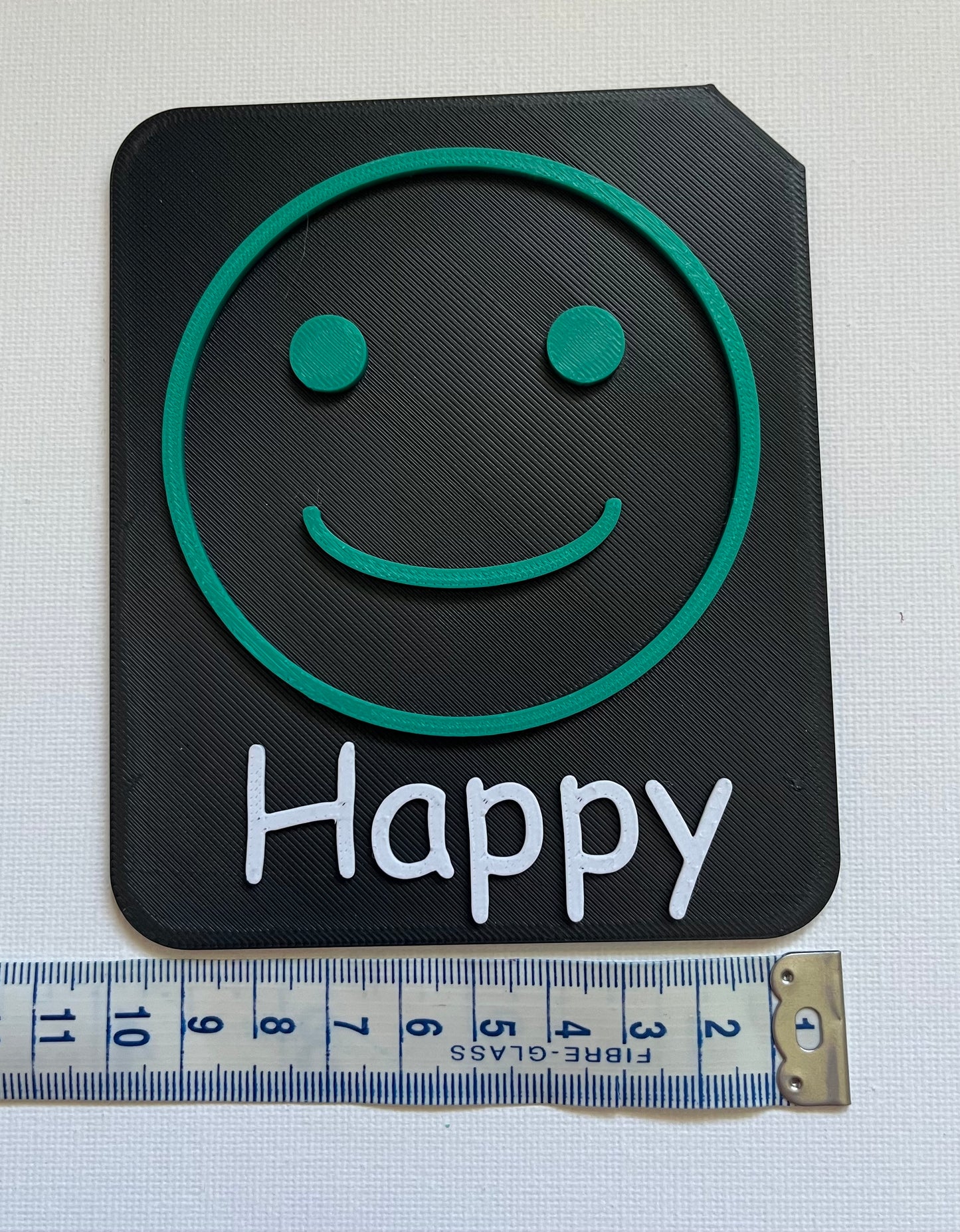 Large 9cm tactile tile showing calm face symbol in Zones of Regulation blue