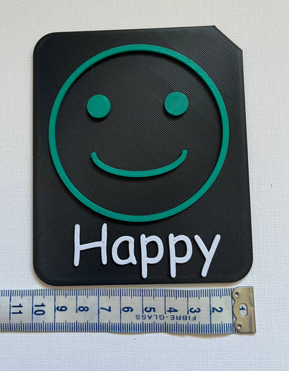 Large 9cm tactile tile showing calm face symbol in Zones of Regulation blue