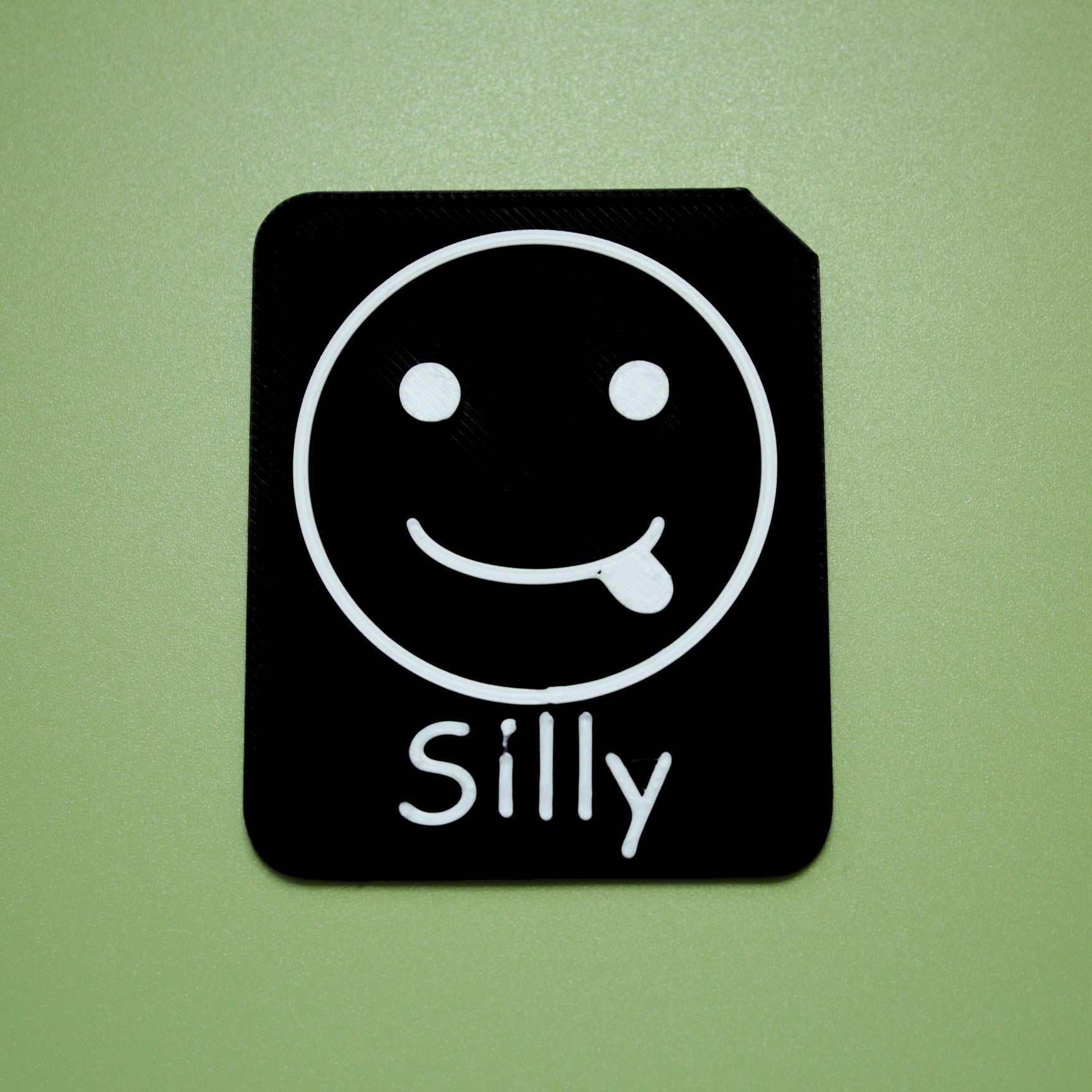 Silly tactile tile - 3D printed raised symbol showing worried face for AAC and SEND communication with vocabulary