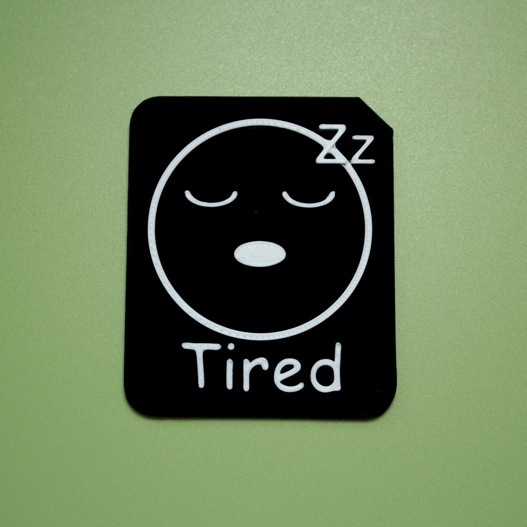 Tired tactile tile - 3D printed raised symbol showing angry face for AAC and SEND communication with vocabulary