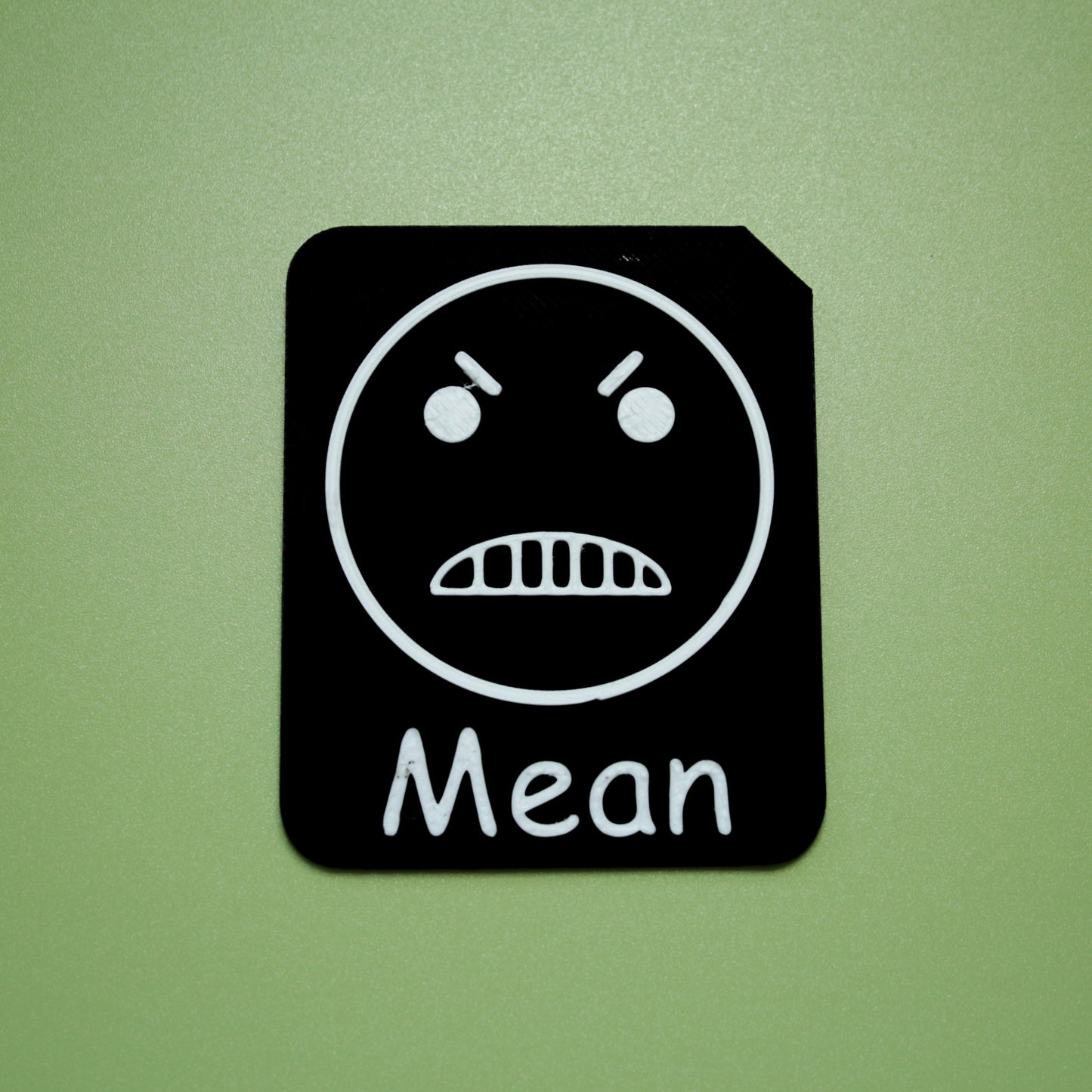 Mean tactile tile - 3D printed raised symbol showing sick face for AAC and SEND communication with vocabulary
