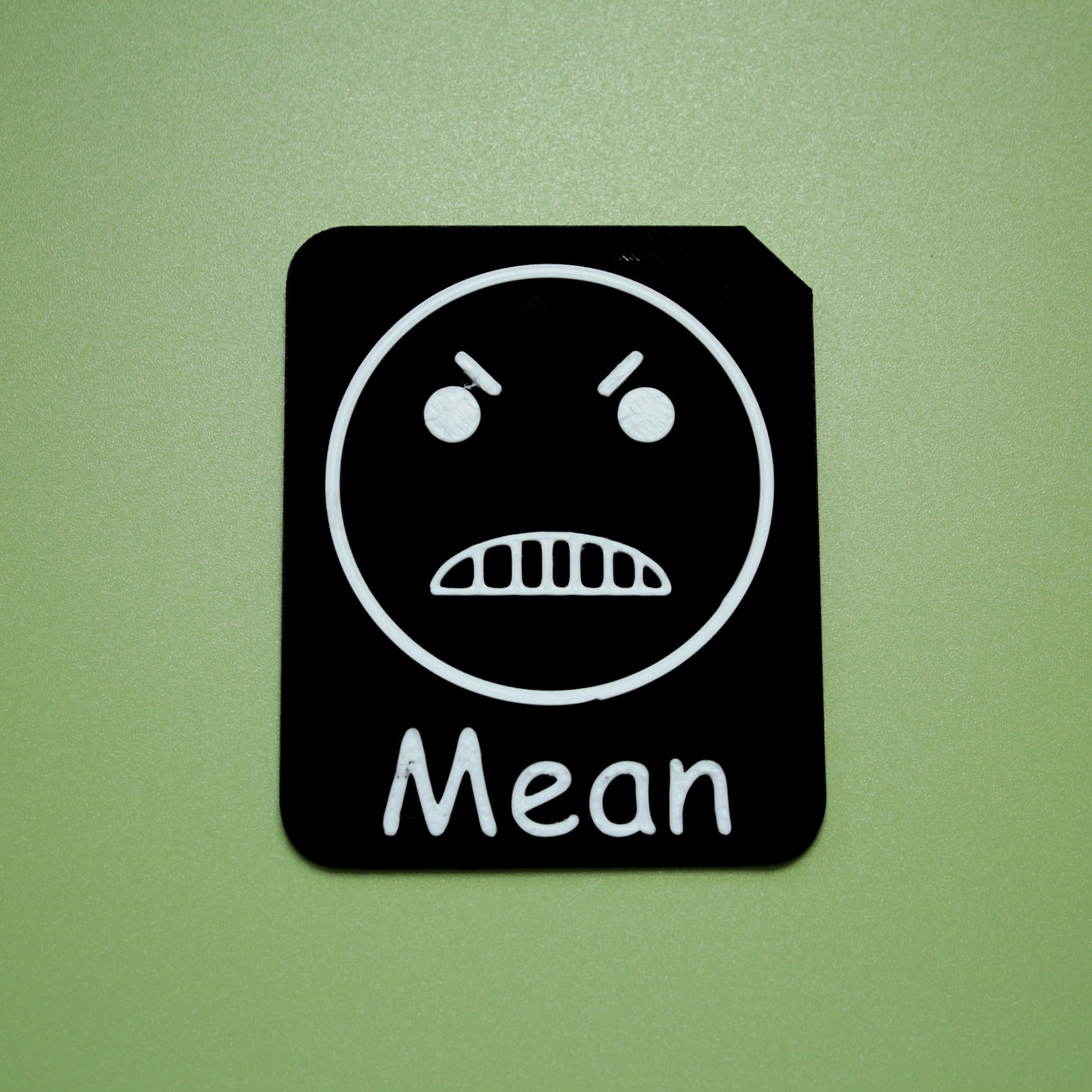 Mean tactile tile - 3D printed raised symbol showing sick face for AAC and SEND communication with vocabulary