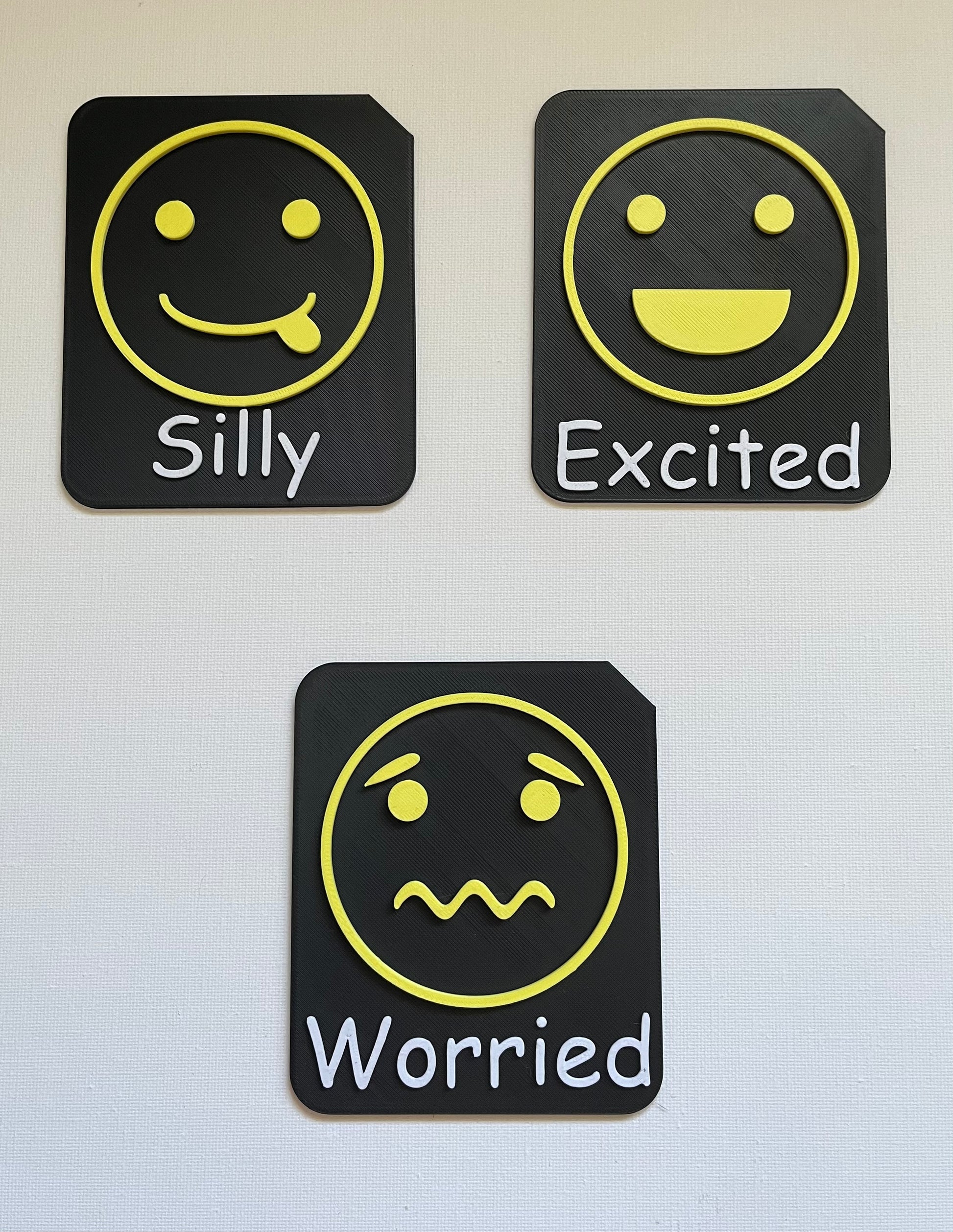 Large format tactile tile showing excited face symbol in yellow Zones of Regulation colour
