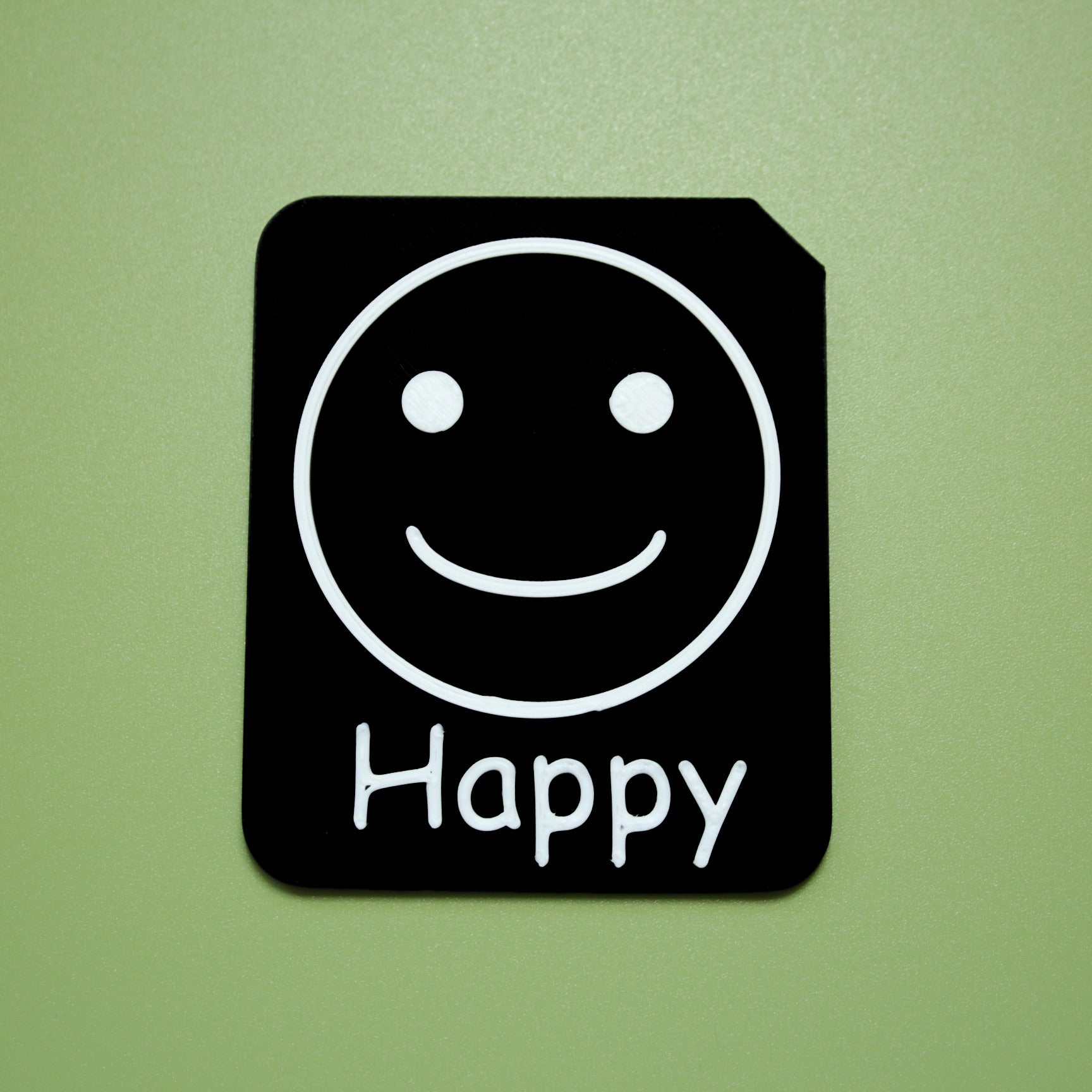 Happy tactile tile - 3D printed raised symbol showing happy face for AAC and SEND communication with vocabulary