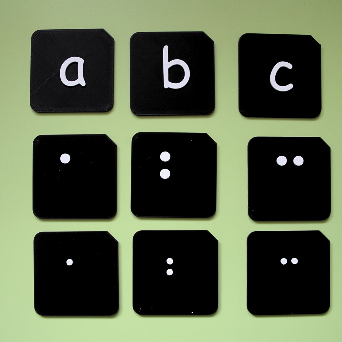 Size comparison of pre-braille alphabet tactile tiles showing different sizes available for VI and SEND learners