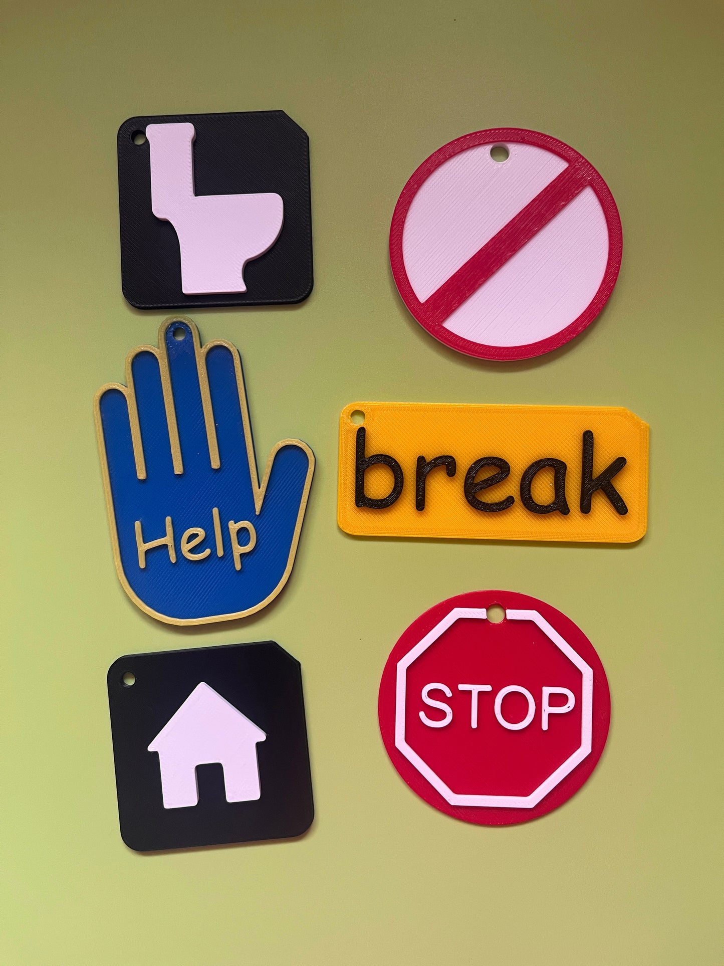Close-up of ASD lanyard accessory symbols showing raised tactile detail for VI and SEND learners