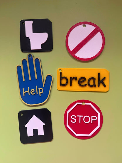 Close-up of ASD lanyard accessory symbols showing raised tactile detail for VI and SEND learners