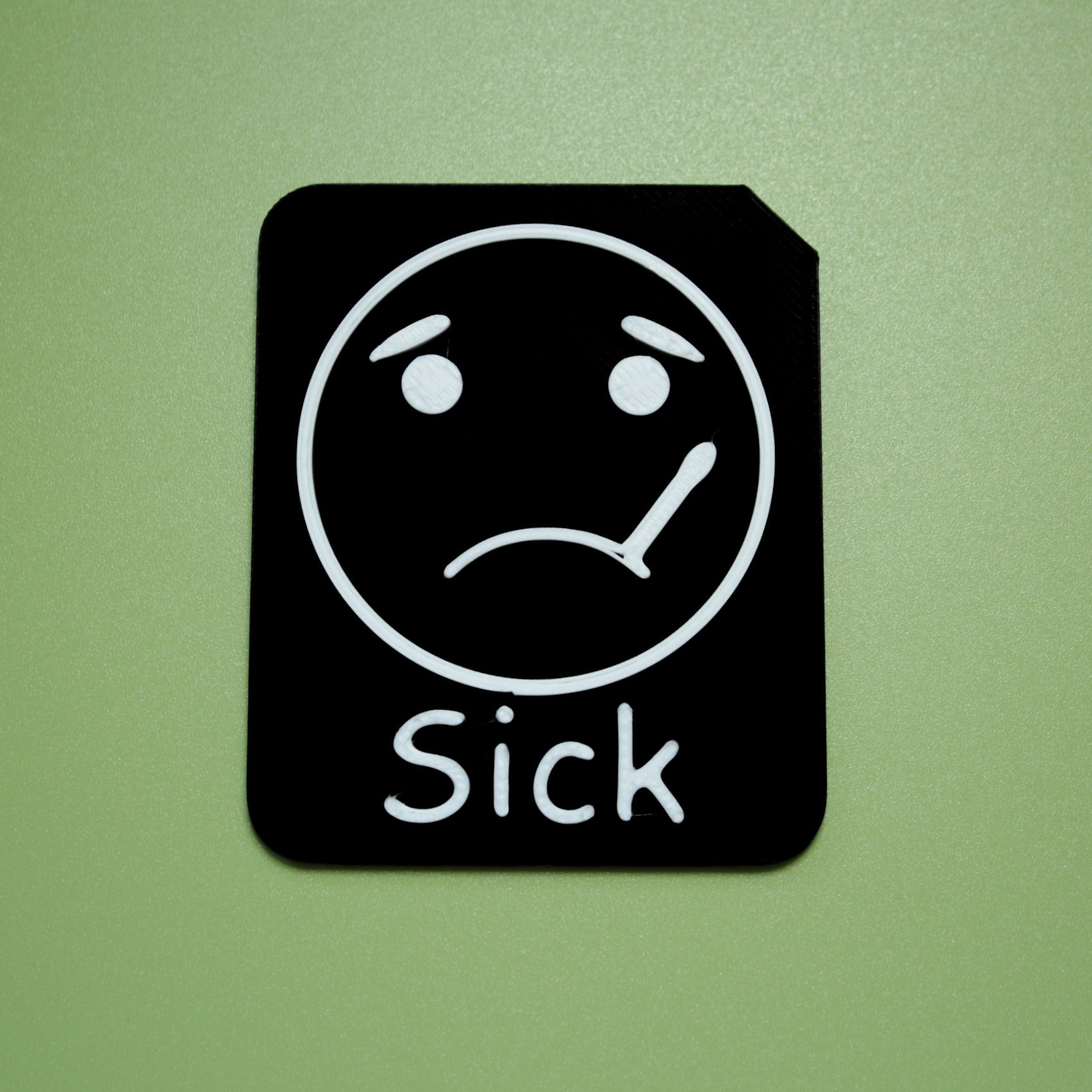 Sick tactile tile - 3D printed raised symbol showing bored face for AAC and SEND communication with vocabulary