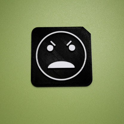 Angry tactile tile - 3D printed raised symbol showing angry face for AAC and SEND communication