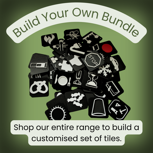 Large selection of tactile communication tiles shown in a pile representing the range of symbols available in the Build Your Own Set for SEND AAC autism and VI learners