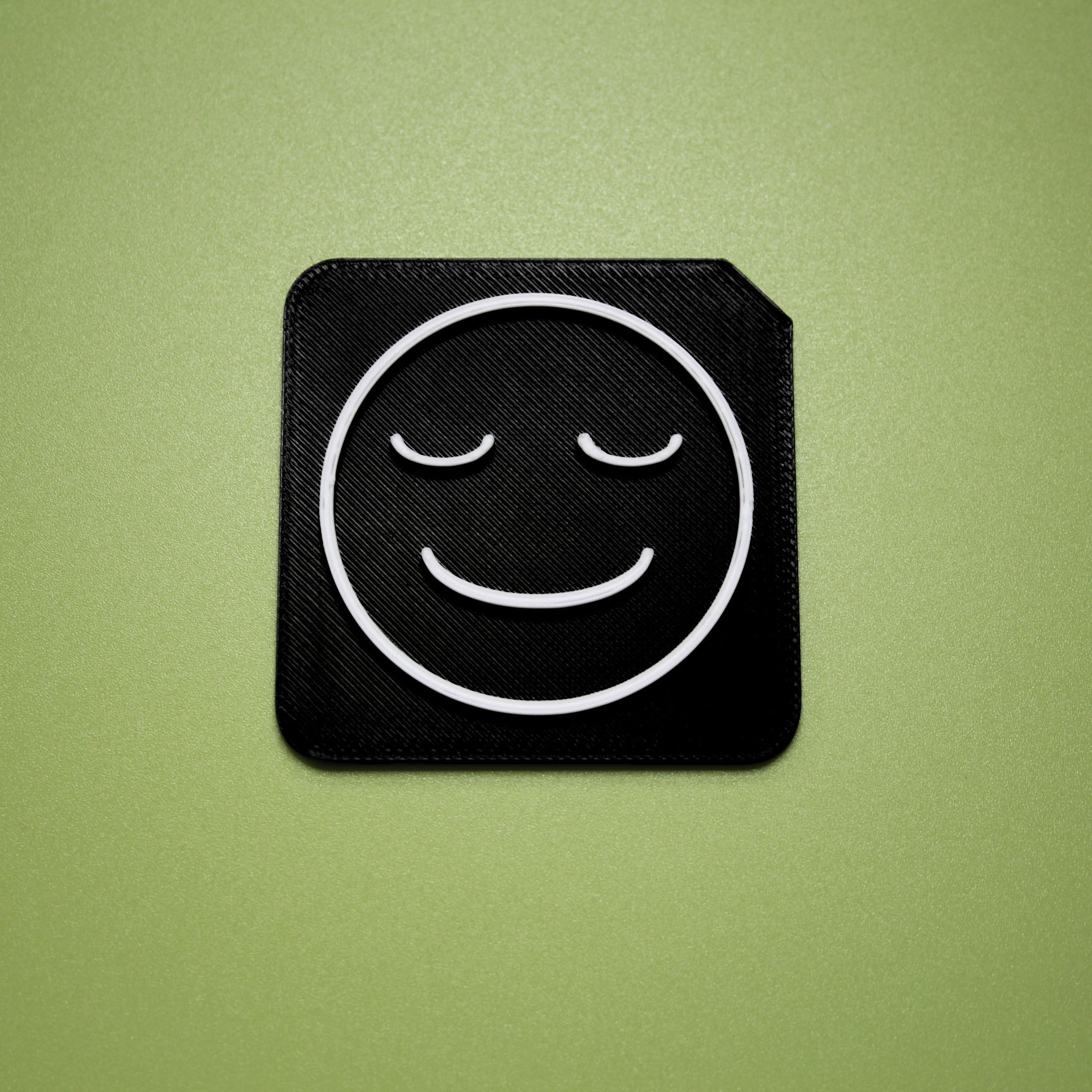 Calm tactile tile - 3D printed raised symbol showing calm face for AAC and SEND communication
