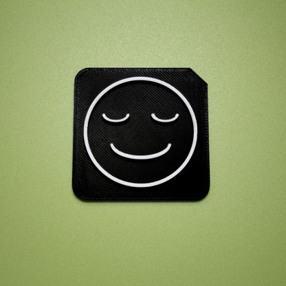 Calm tactile tile - 3D printed raised symbol showing calm face for AAC and SEND communication