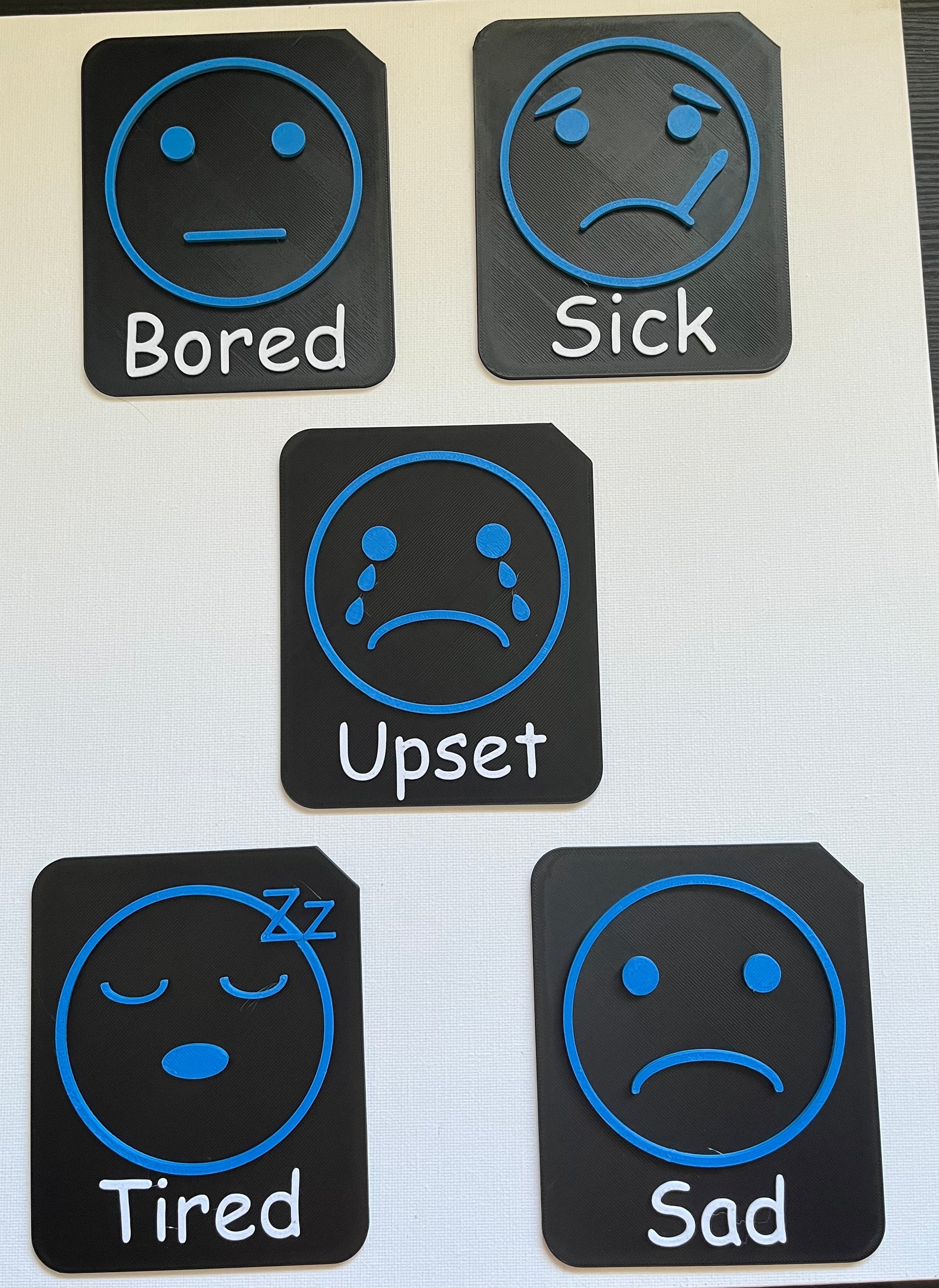 Large format tactile tile showing angry face symbol for SEND emotional literacy support