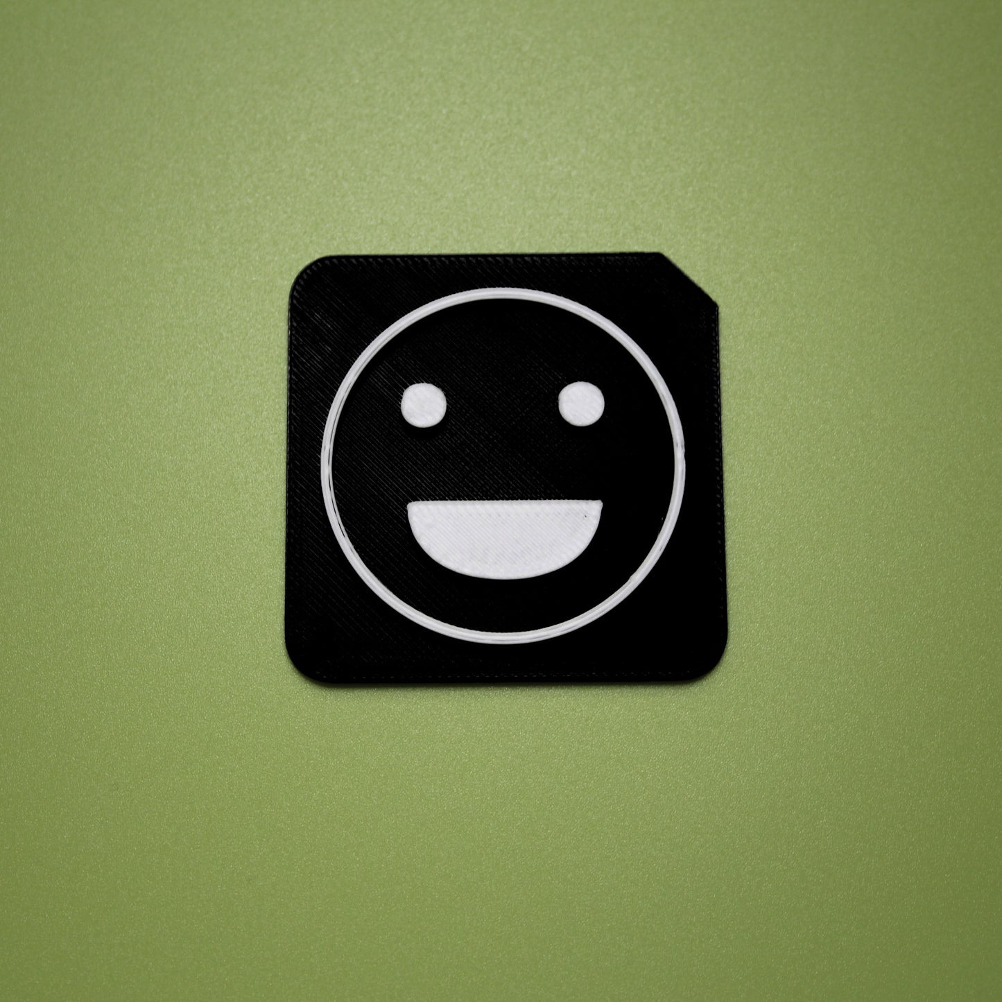 Excited tactile tile - 3D printed raised symbol showing excited face for AAC and SEND communication