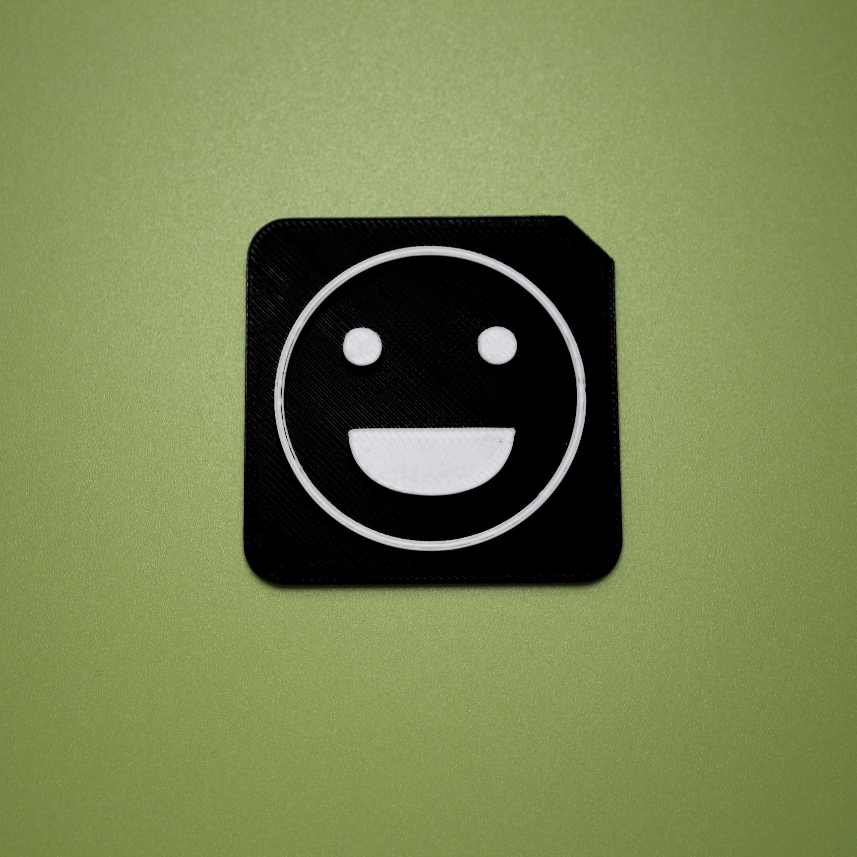 Excited tactile tile - 3D printed raised symbol showing excited face for AAC and SEND communication