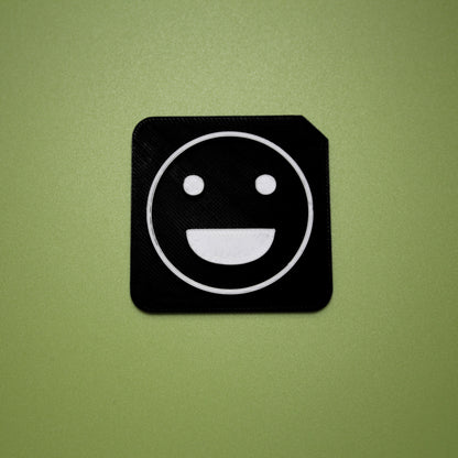 Excited tactile tile - 3D printed raised symbol showing excited face for AAC and SEND communication