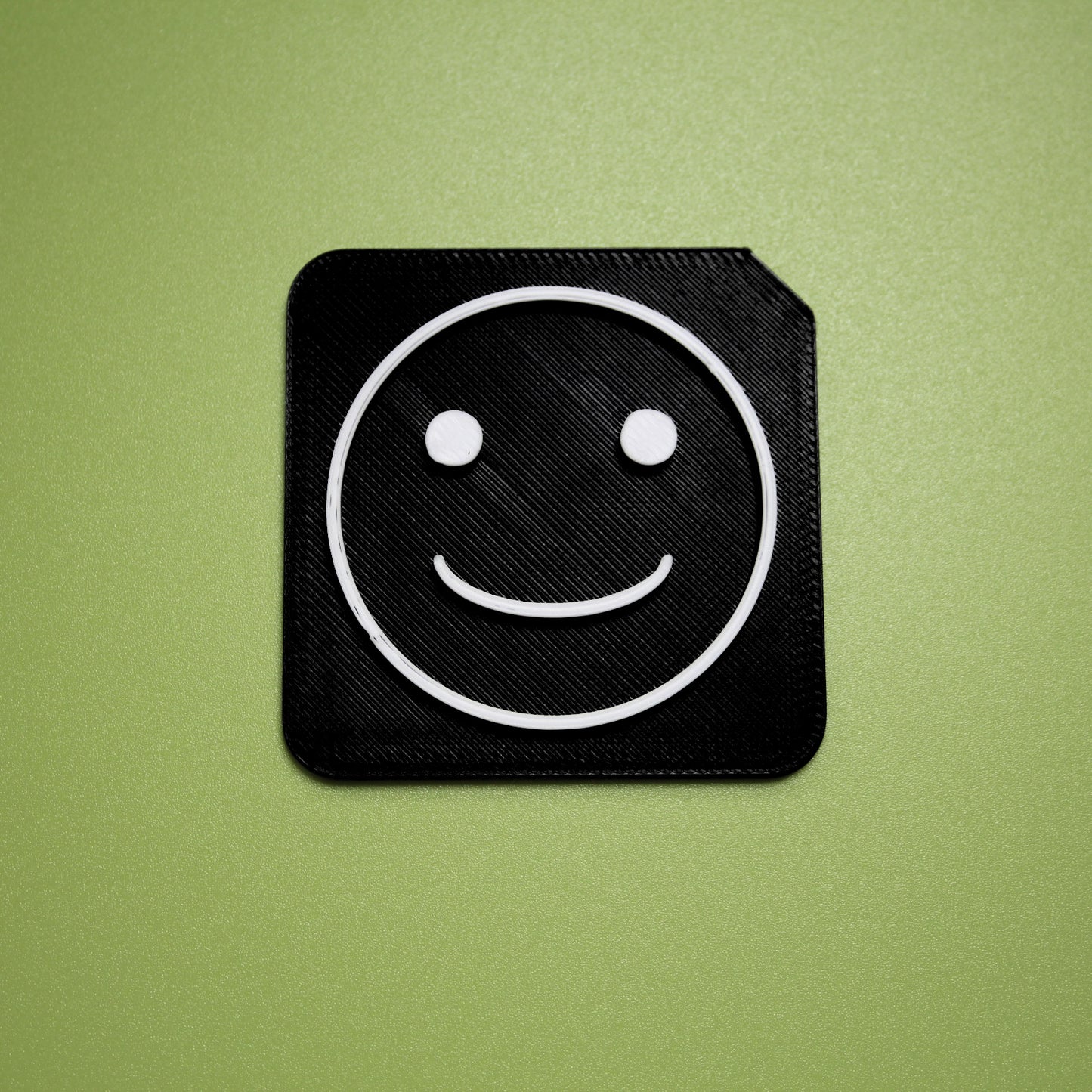 Happy tactile tile - 3D printed raised symbol showing happy face for AAC and SEND communication