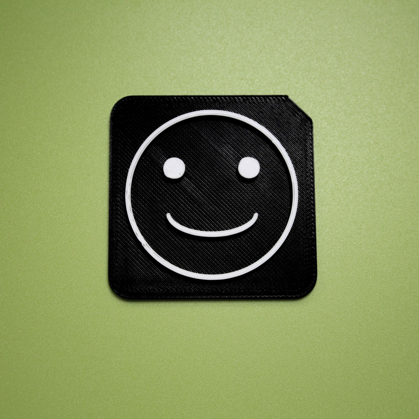 Happy tactile tile - 3D printed raised symbol showing happy face for AAC and SEND communication