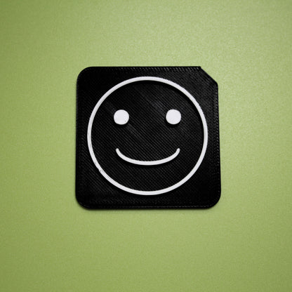 Happy tactile tile - 3D printed raised symbol showing happy face for AAC and SEND communication