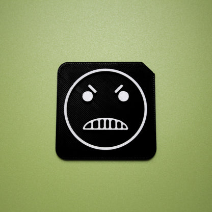 Mean tactile tile - 3D printed raised symbol showing mean face for AAC and SEND communication