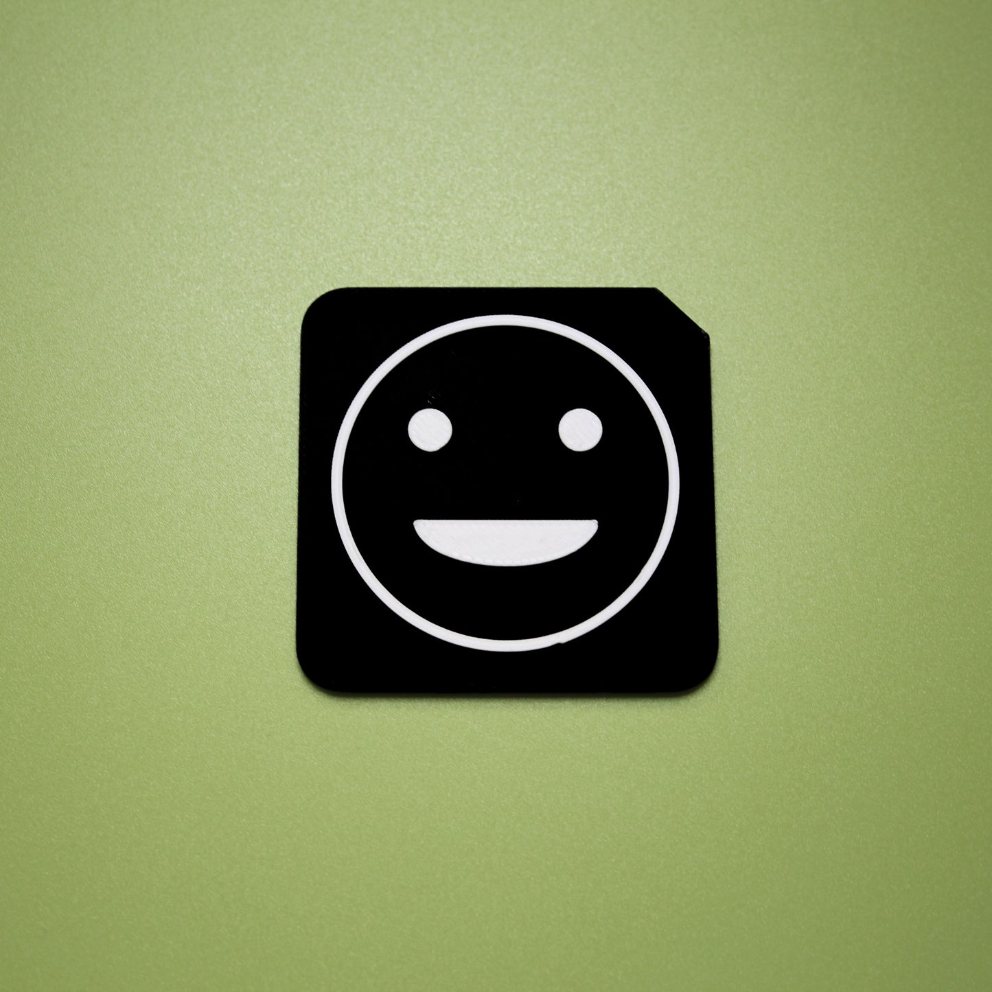 Proud tactile tile - 3D printed raised symbol showing proud face for AAC and SEND communication