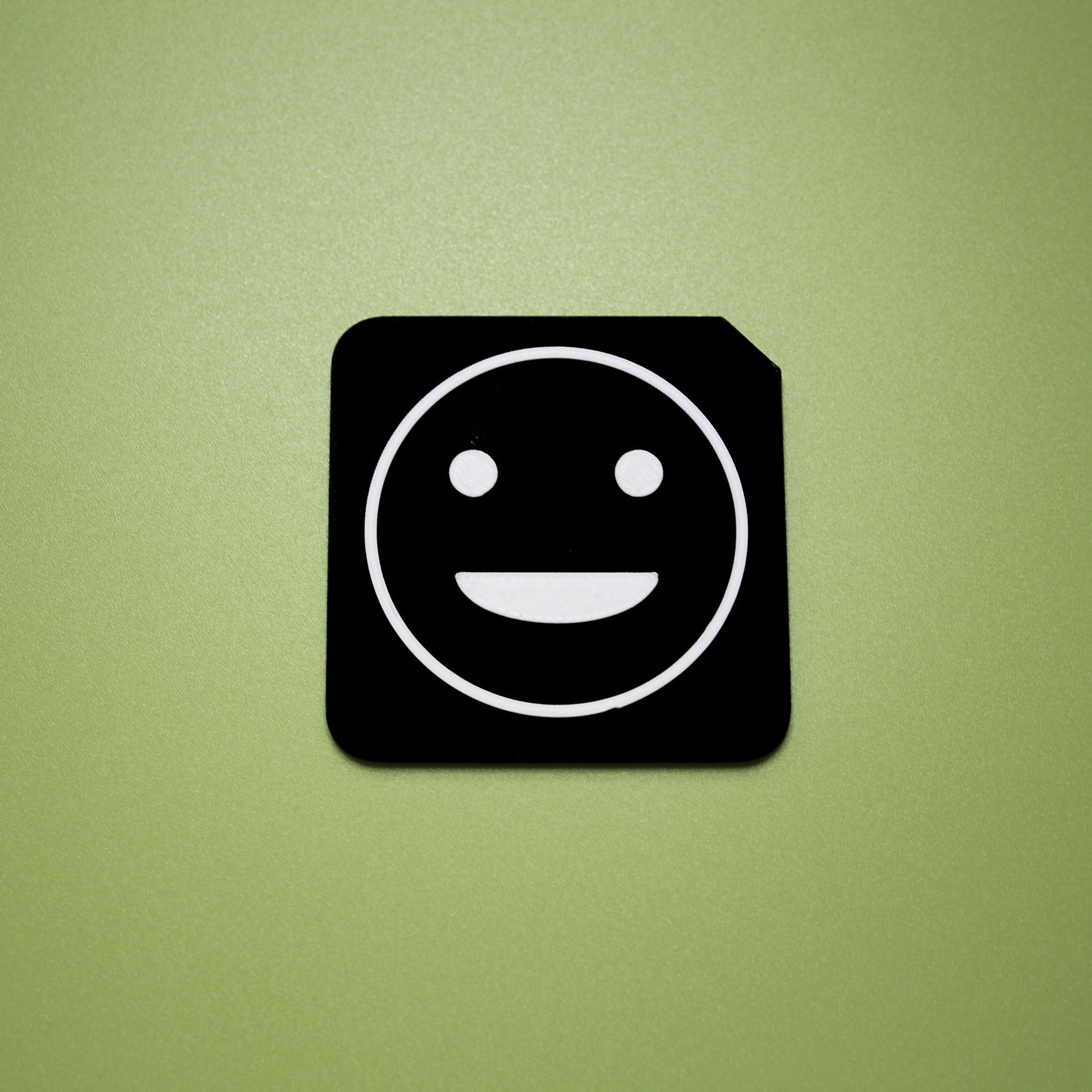 Proud tactile tile - 3D printed raised symbol showing proud face for AAC and SEND communication