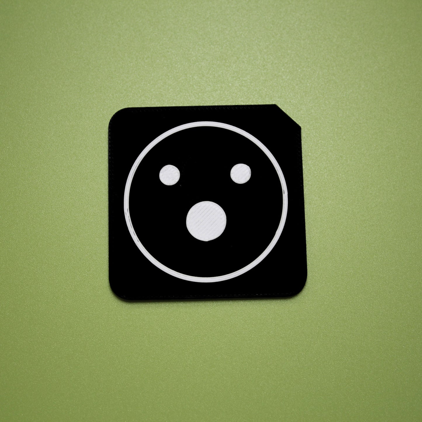 Shocked tactile tile - 3D printed raised symbol showing shocked face for AAC and SEND communication