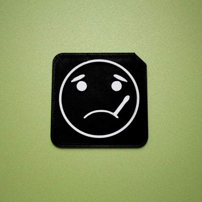 Sick tactile tile - 3D printed raised symbol showing sick face for AAC and SEND communication