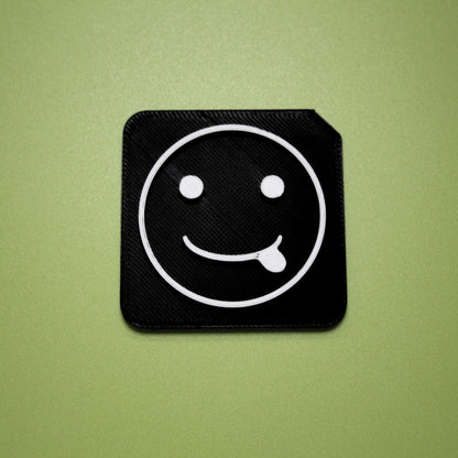 Silly tactile tile - 3D printed raised symbol showing silly face for AAC and SEND communication