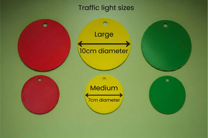 Three traffic light discs clipped to a lanyard for classroom behaviour regulation