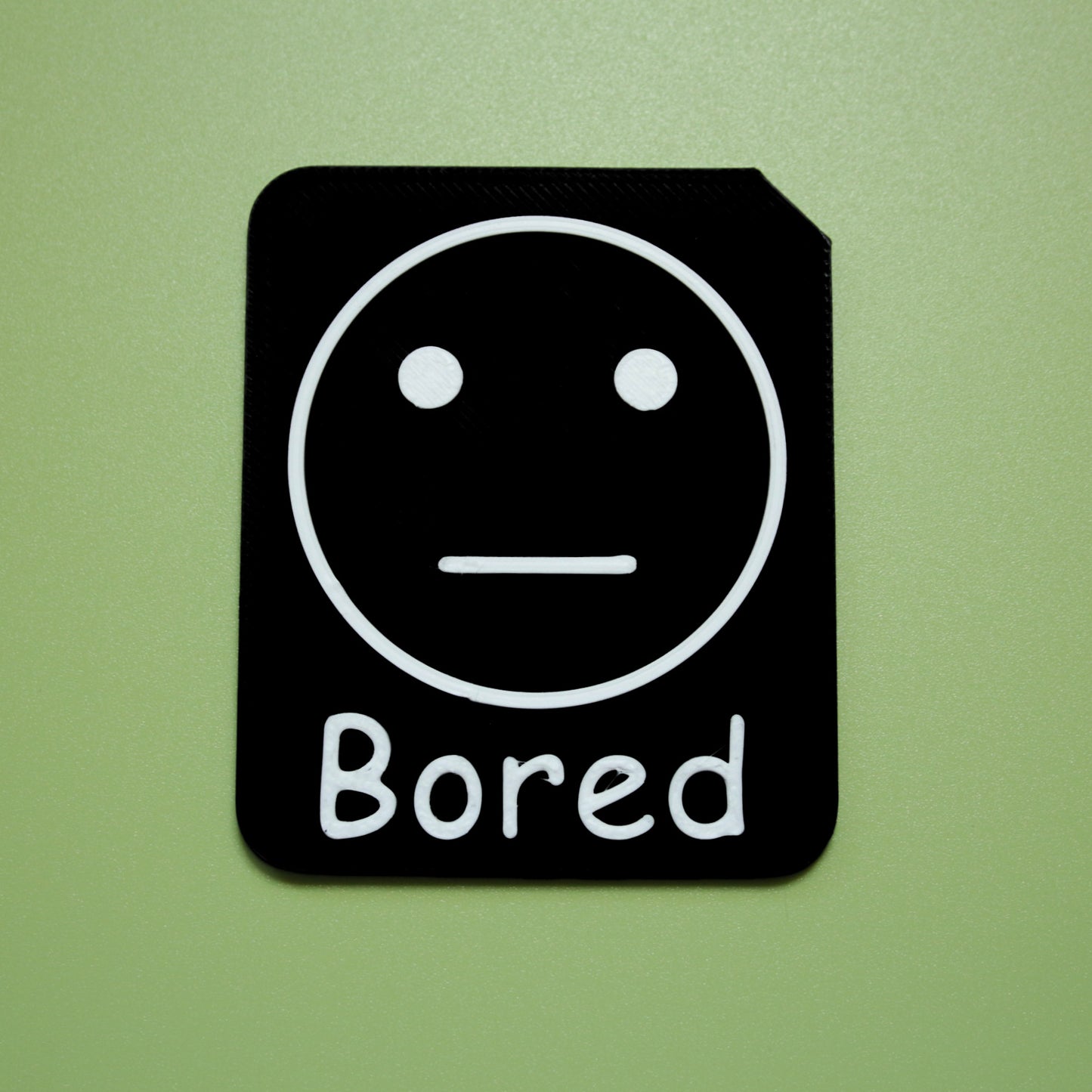 Bored tactile tile - 3D printed raised symbol showing silly face for AAC and SEND communication with vocabulary