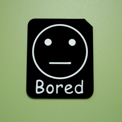 Bored tactile tile - 3D printed raised symbol showing silly face for AAC and SEND communication with vocabulary