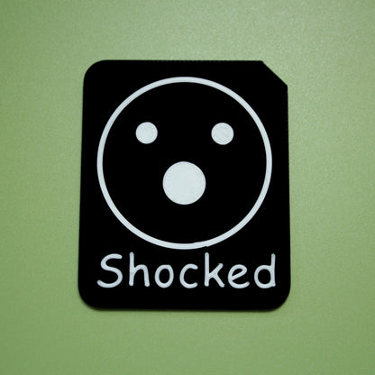Shocked tactile tile - 3D printed raised symbol showing proud face for AAC and SEND communication with vocabulary
