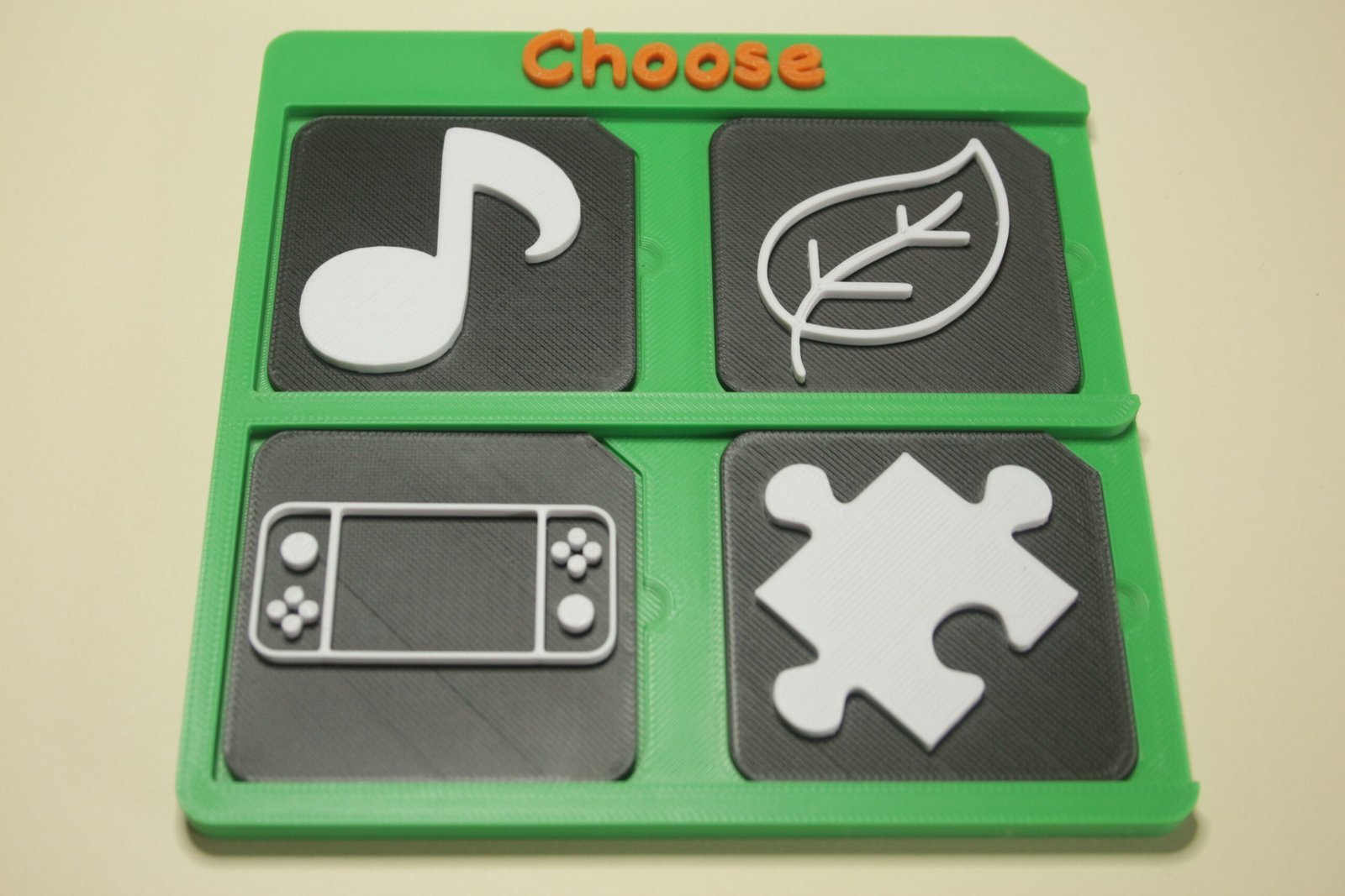 Tactile tiles arranged on a 3d printed choose board indicating choice of an activity
