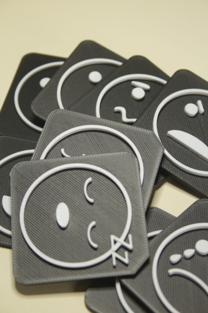 Durable tactile AAC tiles with emotion symbols used in communication