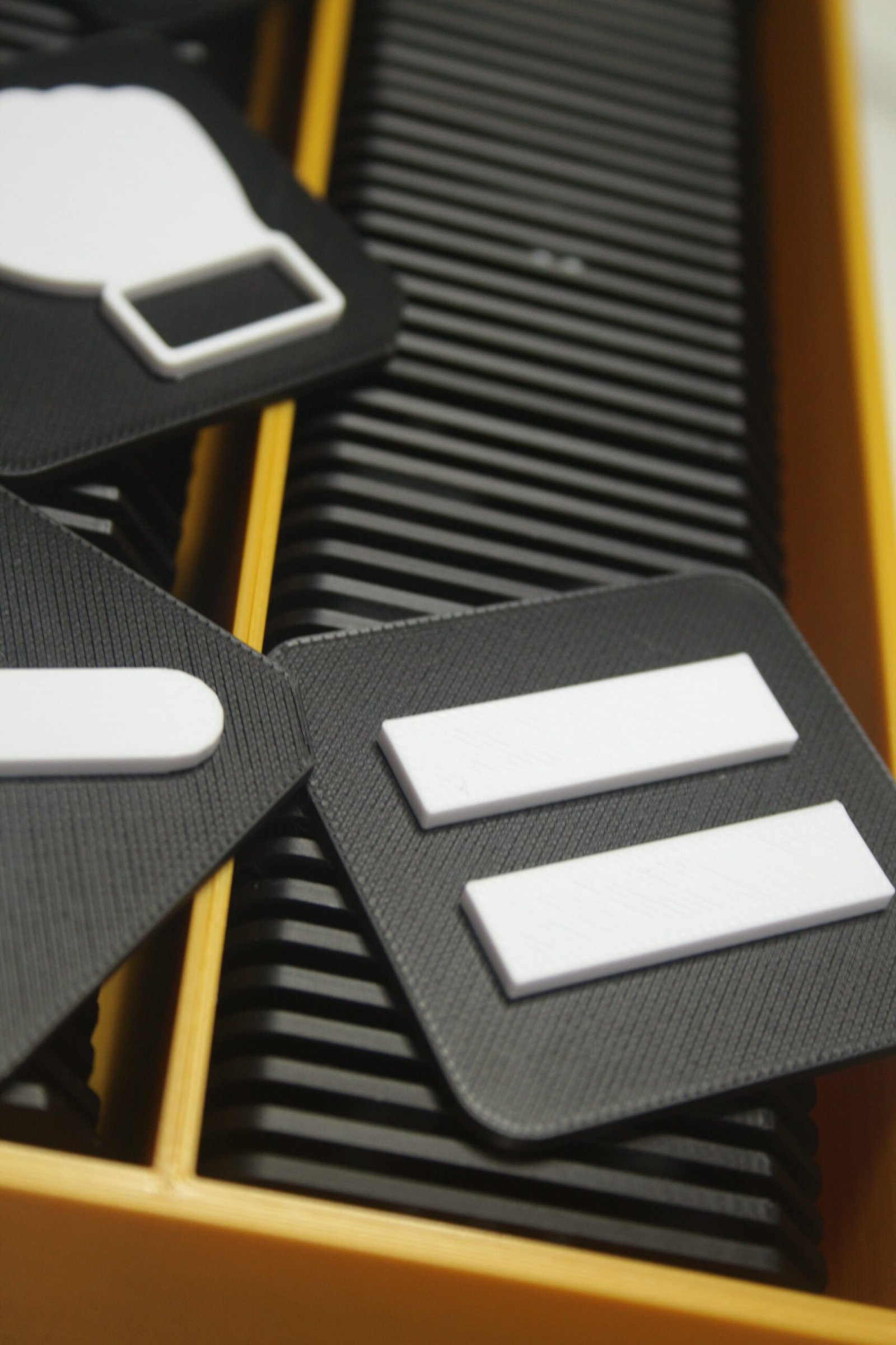 Close up of communication tiles showing clear raised symbols and cut corner for orientation