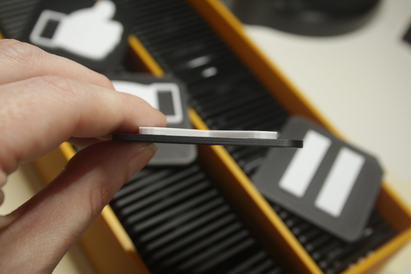 Close up of tactile communication tiles showing clear raised symbols and thickness of a Tactile communication tile.
